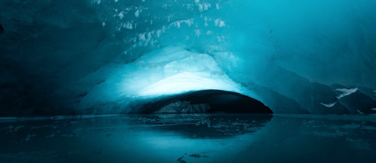 Glowing blue ice cave inside a Svalbard glacier